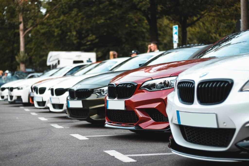 Row of premium sports cars lined up in a parking lot