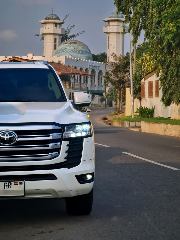 White Toyota Land Cruiser on a street in Ghana
